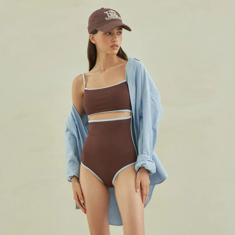 Brown one-piece swimsuit for women with triangle neckline on a mannequin