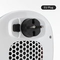 White ceramic heating electric heater with digital display and remote control on a table.