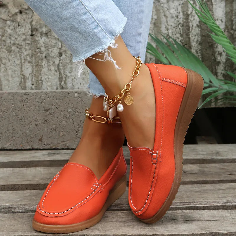 Women's flat slip-on loafers in PU leather, showing round toe and available colour options