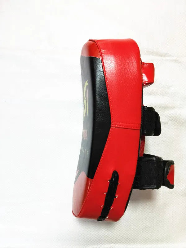 Black square boxing target pad with red trim and a double buckle strap on the back