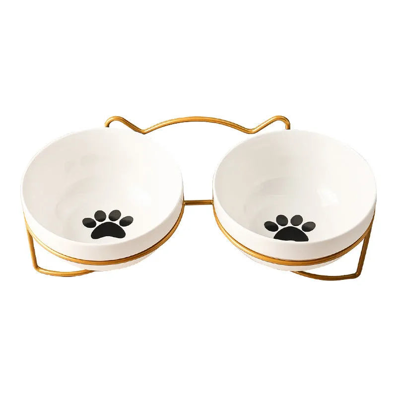 White ceramic cat bowl with cat paw print pattern in a black iron cat-ear frame