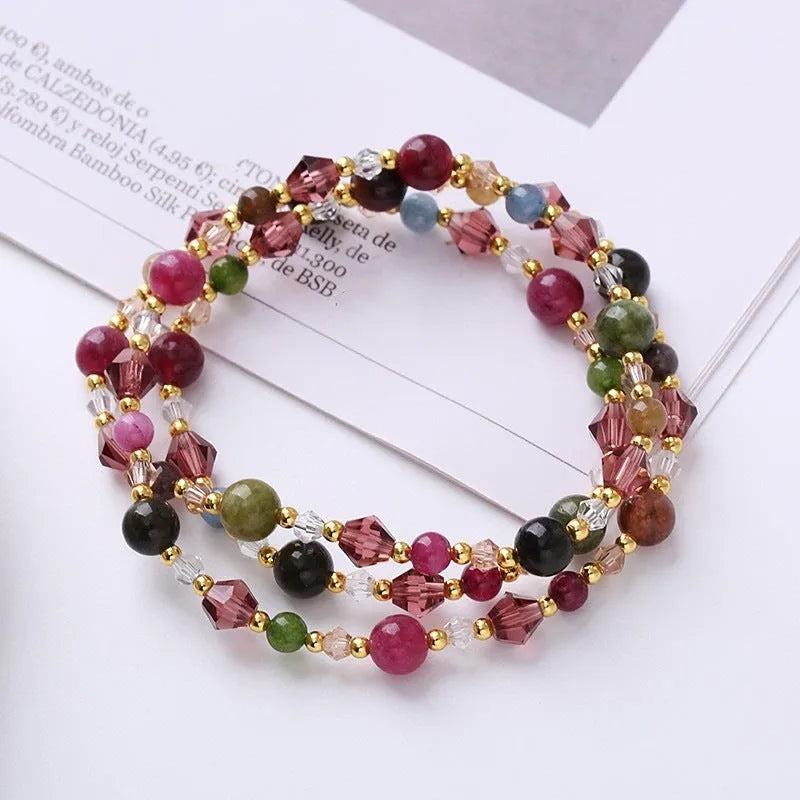 Women's adjustable three-ring crystal bracelet with colourful gemstones on wrist