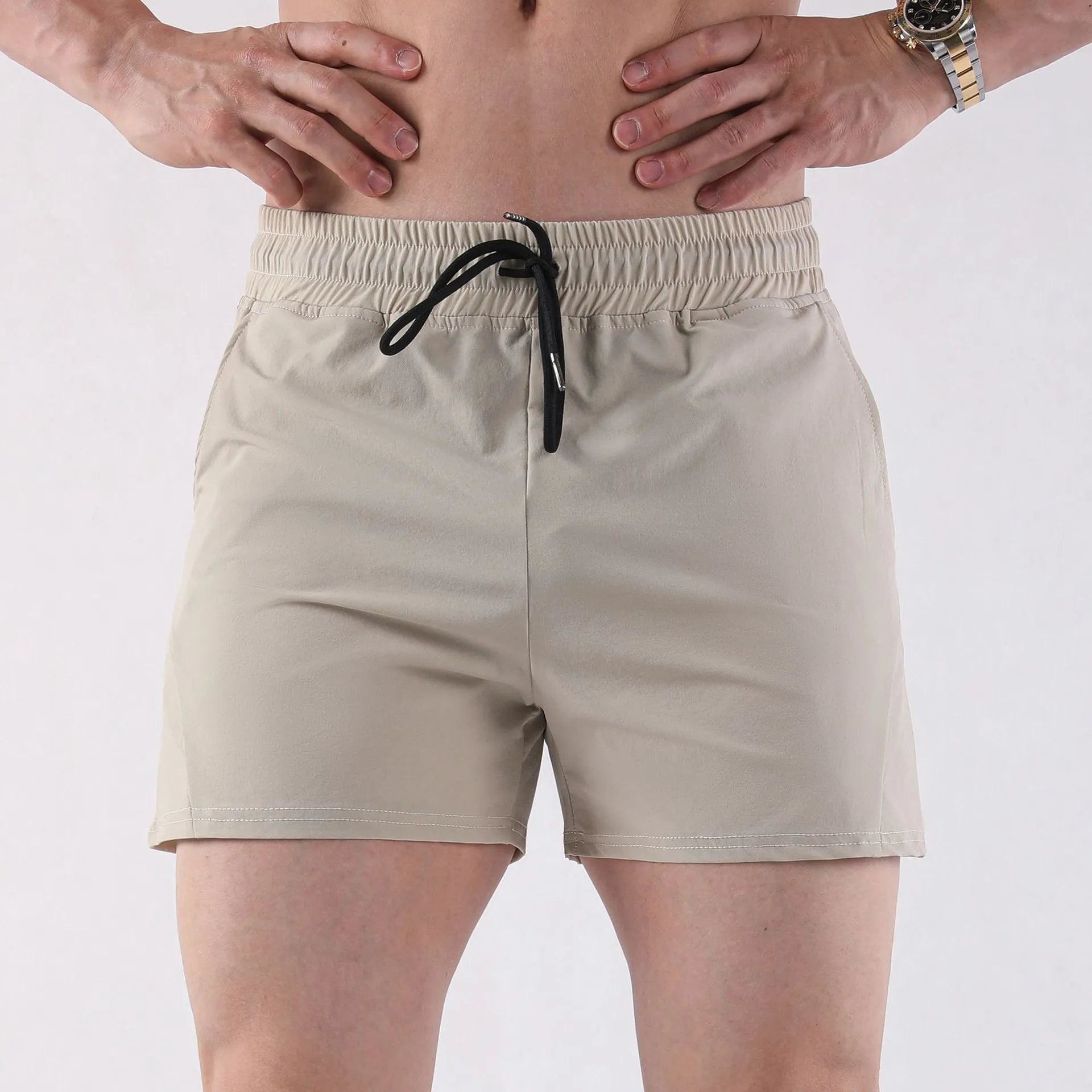 Men's thin grey polyester basketball shorts with an elastic waistband for summer sports.