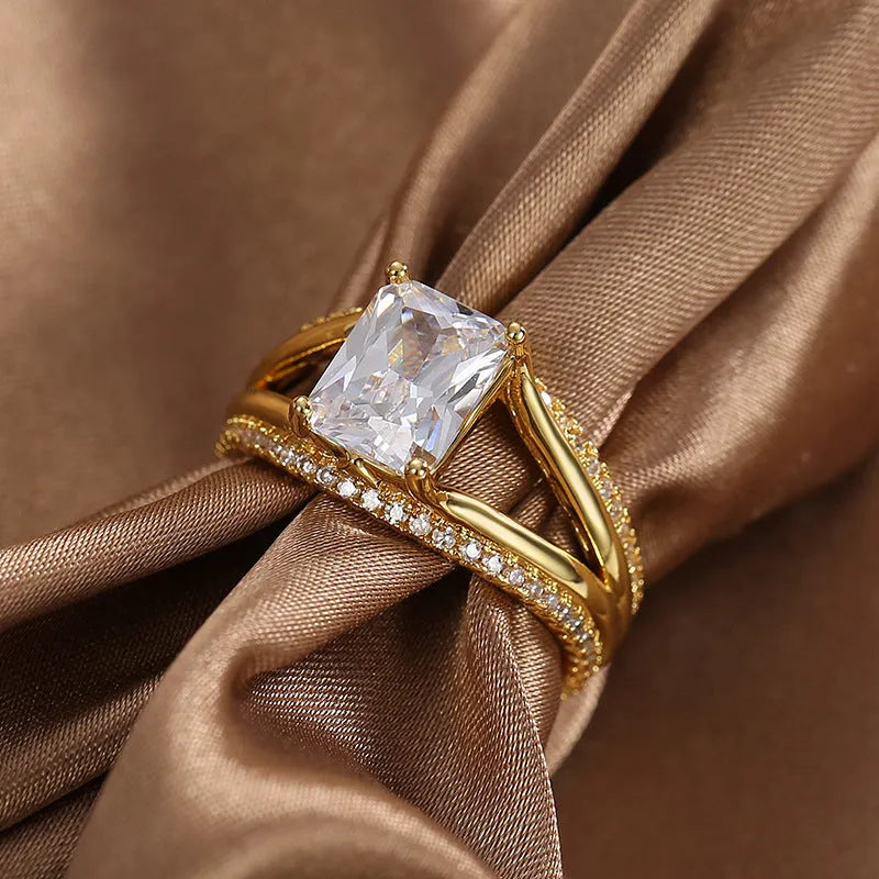 Gold geometric zircon ring for women on a plain background, showing its electroplated copper construction and minimalist design.