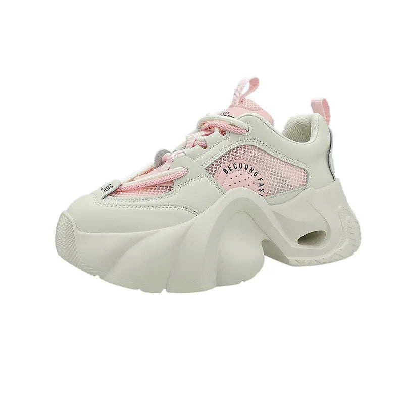 Women's beige sneakers with a cross shoulder strap and thick rubber sole on a white background.