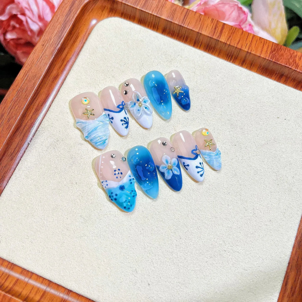 Blue hand-painted carved summer ice transparent plastic fake nails set in sizes XS, S, M, L.