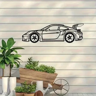 Black iron metal sports car wall art decoration against a wall