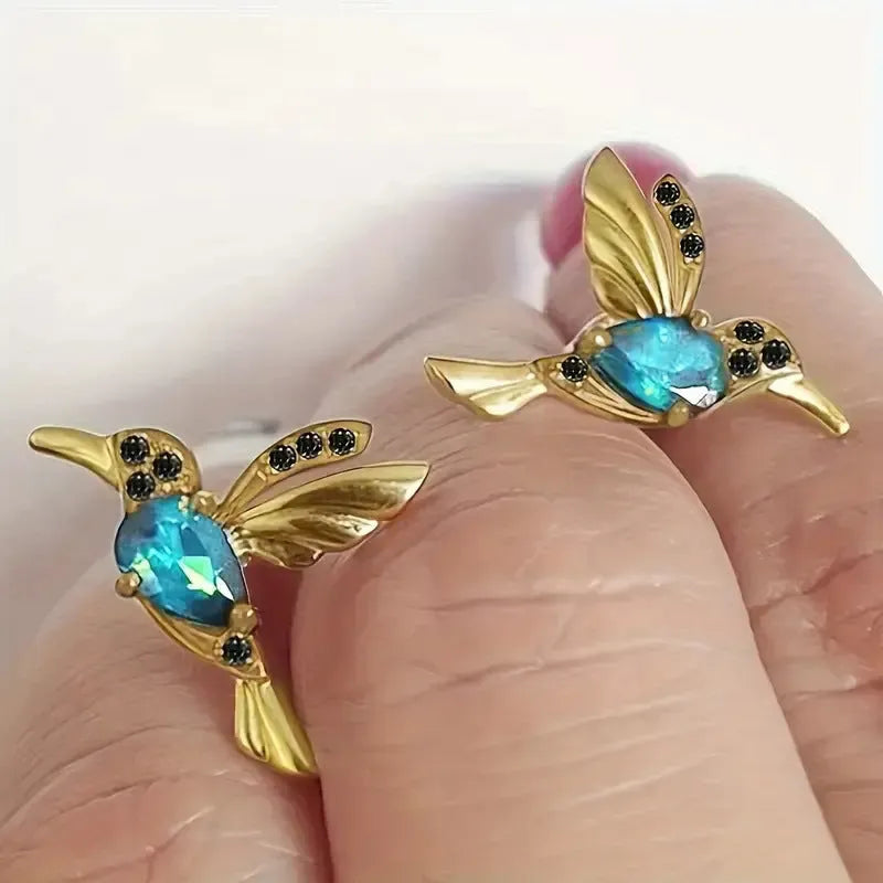 Long drop bird shaped alloy earrings for women with zirconium wings, shown in blue, red, and red lvzuan colour variations.