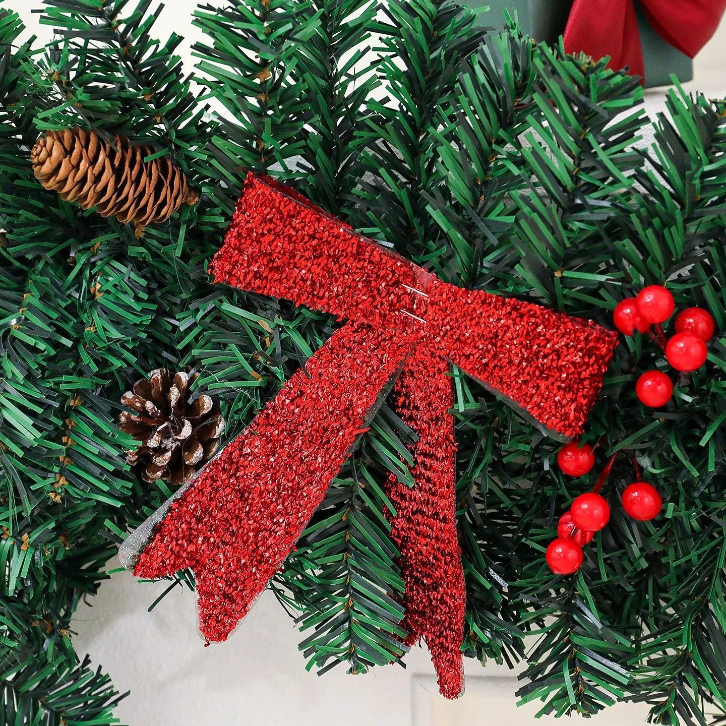 Christmas decorative rattan cane with pine cones and a red bow, available with or without integrated LED lights