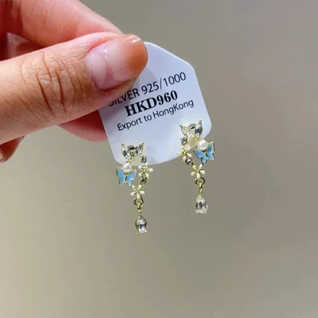 Alloy geometric heart ear clip with rhinestones and a star tassel, shown in a light luxury fresh style.