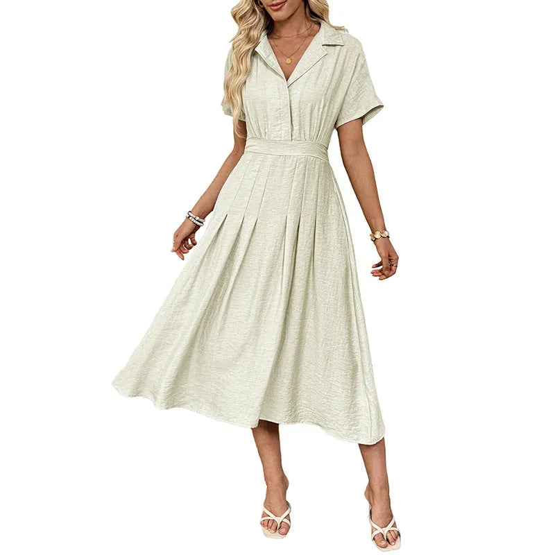 Light green knee-length shirt dress with lapel collar, waist tie, and side pockets on mannequin