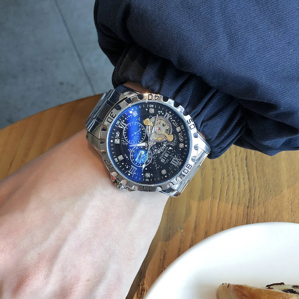 Men's silver stainless steel automatic watch with starry black dial and luminous hands on a black leather strap