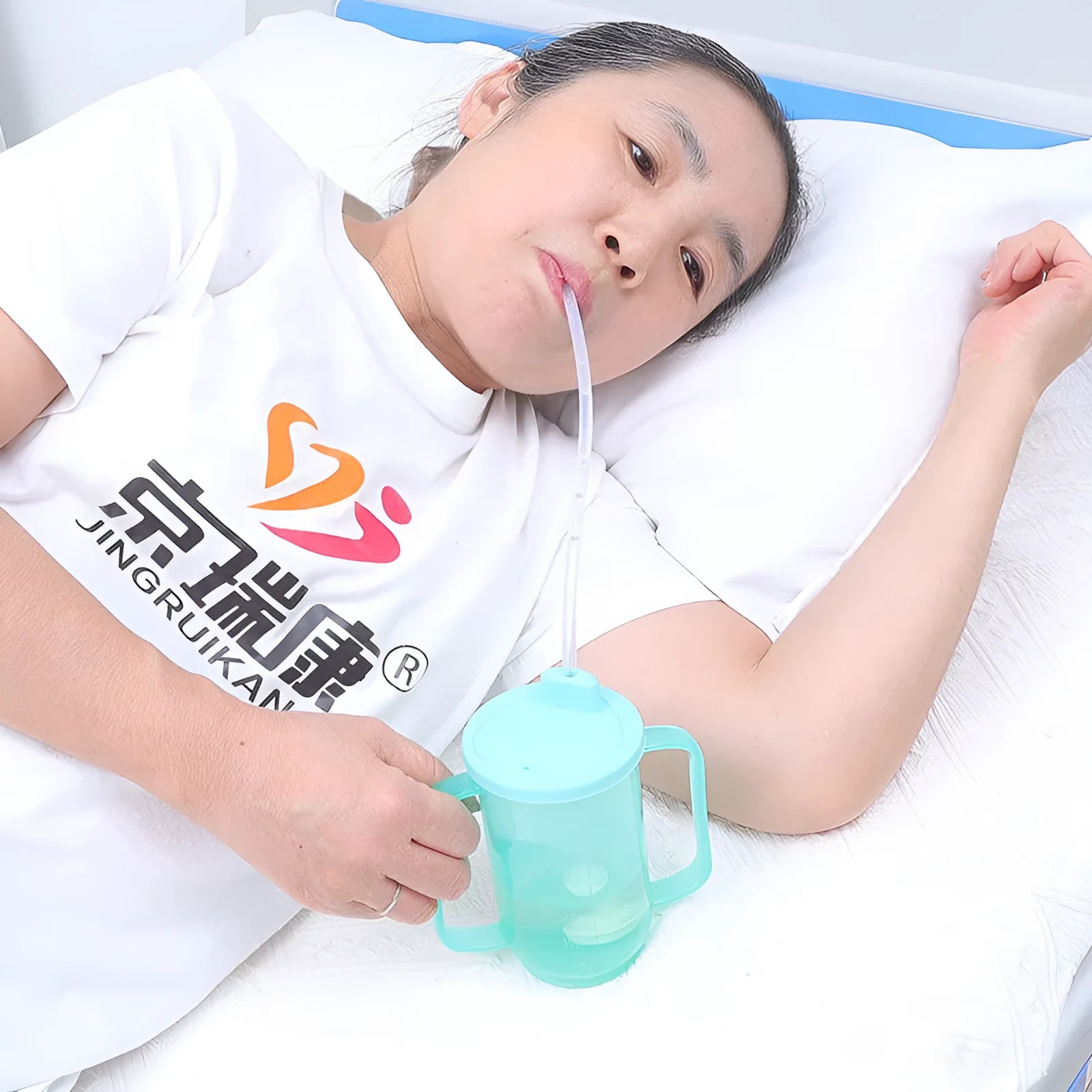 PP plastic anti-choke drinking cup with slanted mouth, handle, and lid for bed care.