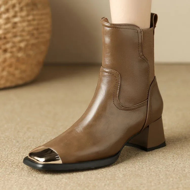 Brown women's Martin heeled leather boots with side zipper and metal rivet details.