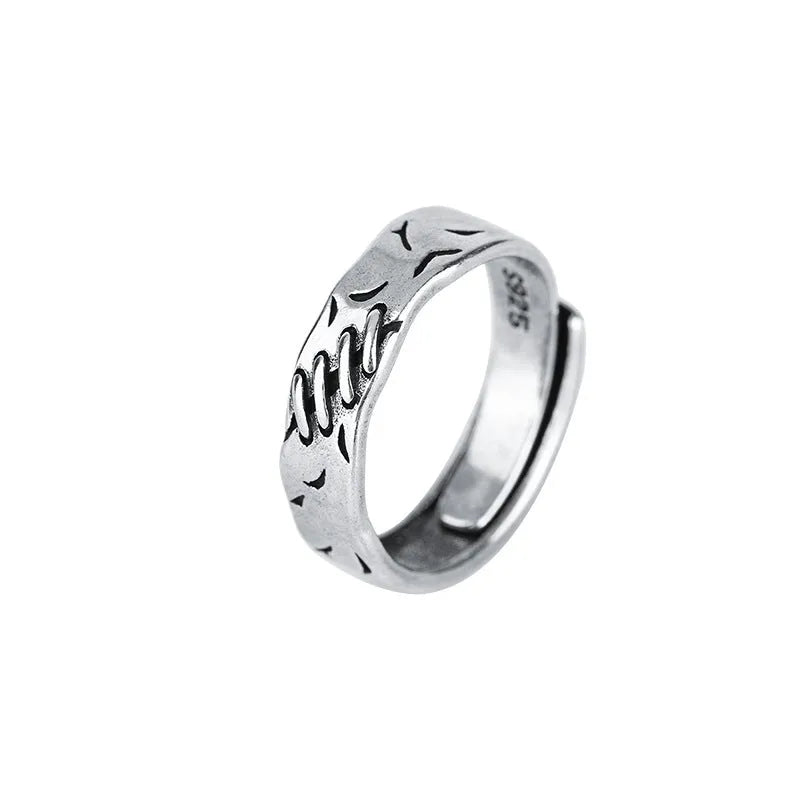 Black geometric copper ring with adjustable opening and oval design elements