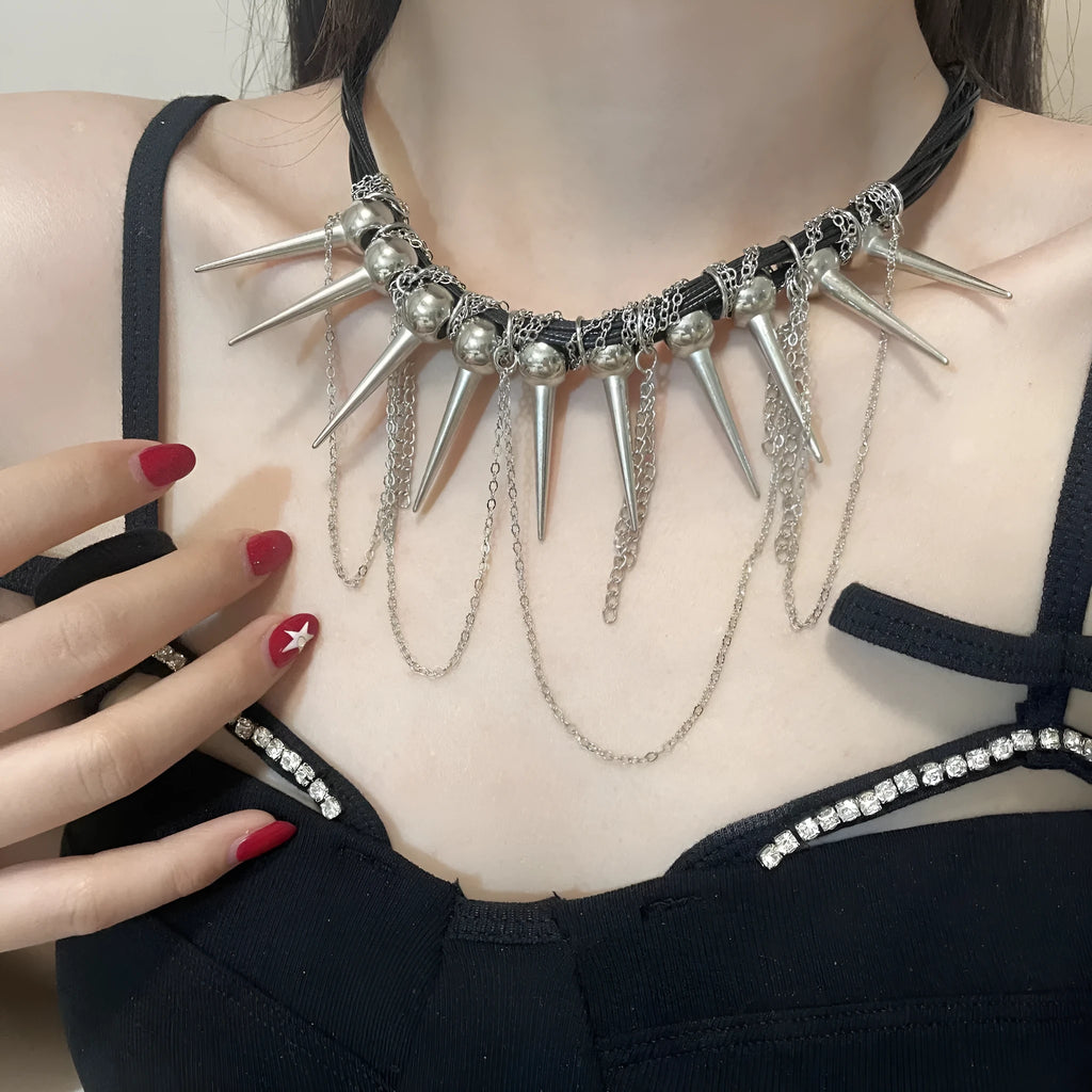 Close-up of a women's casual necklace with leather cord, electroplated round beads, and point rivets in a winding tassel design.