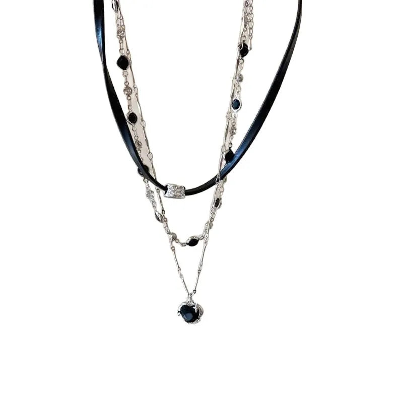 Women's twin necklace set with alloy heart pendants, artificial crystal details, and leather elements on clavicle chains