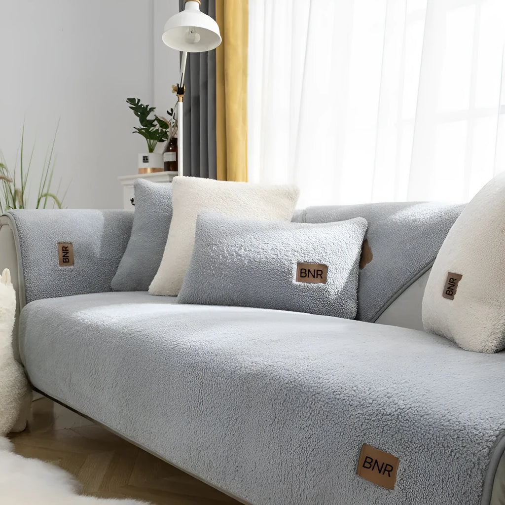 Lambswool solid colour sofa cover in blue, shown on a three-seater sofa.