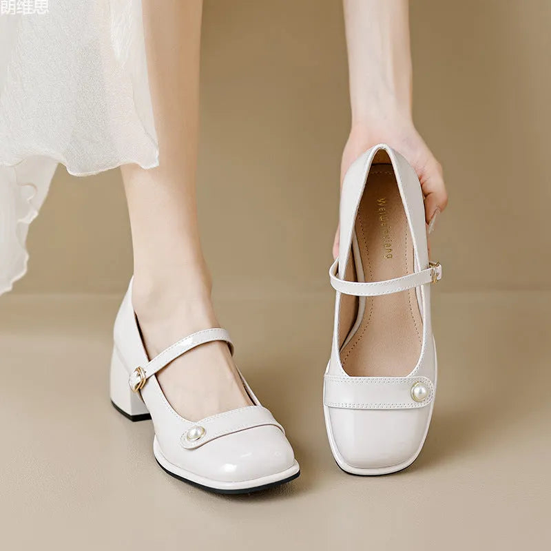Women's apricot patent leather chunky heel pumps with a square toe and front buckle fastening.