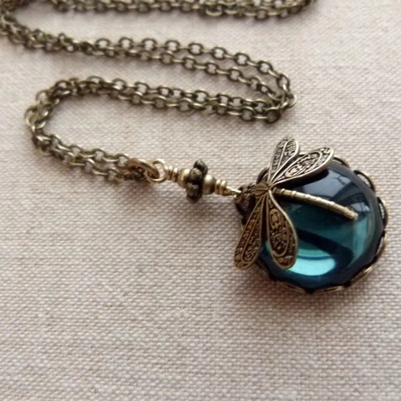 Yellow vintage bronze dragonfly pendant necklace on a silver chain, hand-carved design.