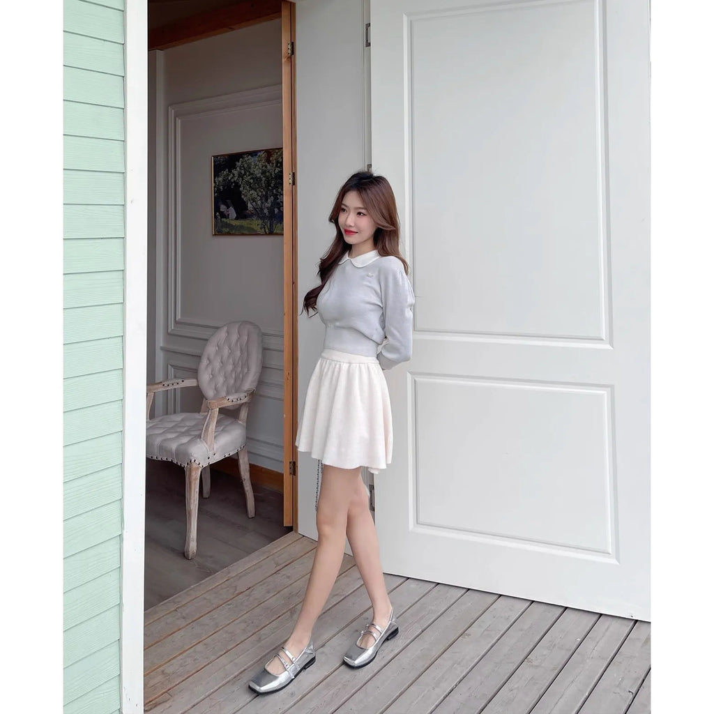 Silver women's Mary Jane ballet flats with cross buckle strap and round toe on flat low heel.