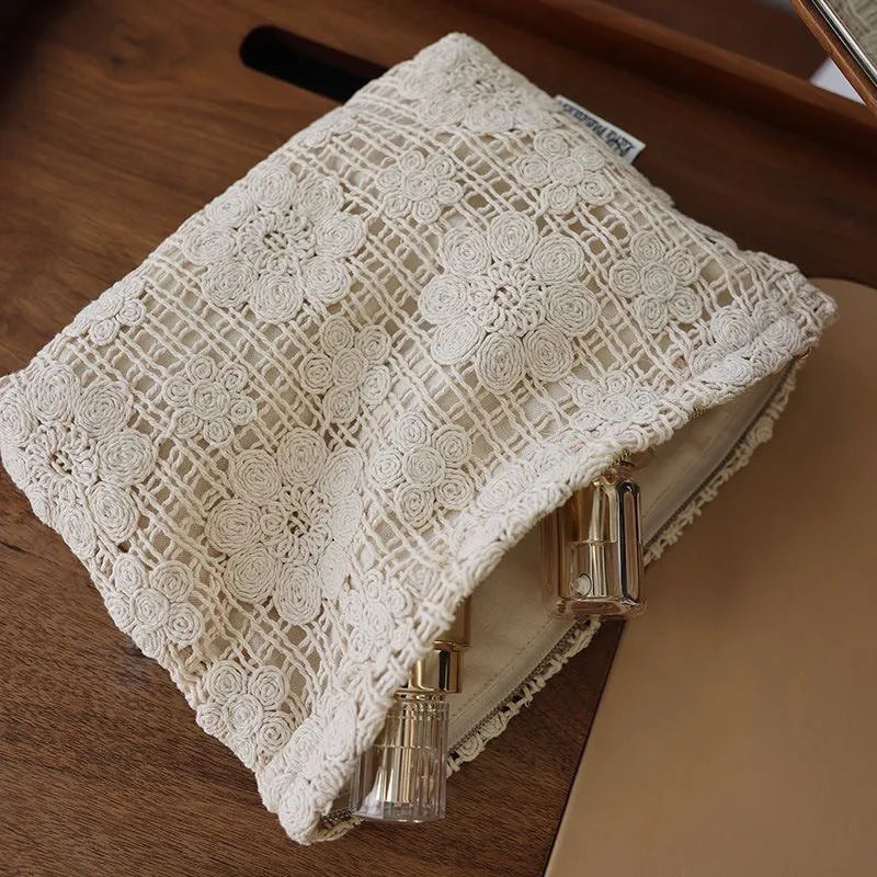 Handmade crocheted cosmetic bag with hollow floral embroidery on solid colour corduroy fabric.
