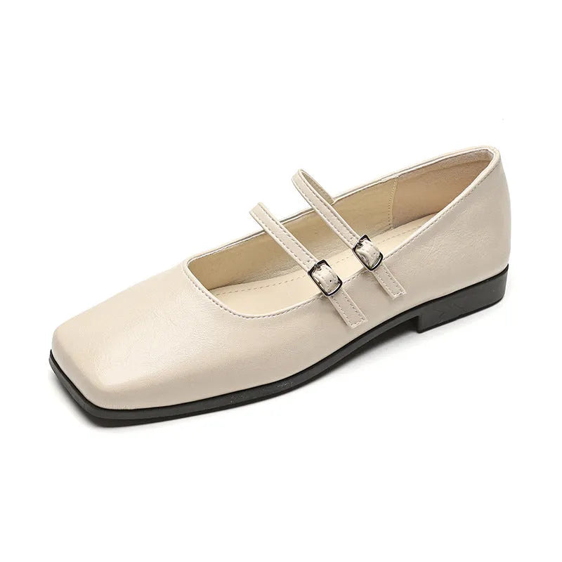 Silver women's Mary Jane ballet flats with cross buckle strap and round toe on flat low heel.