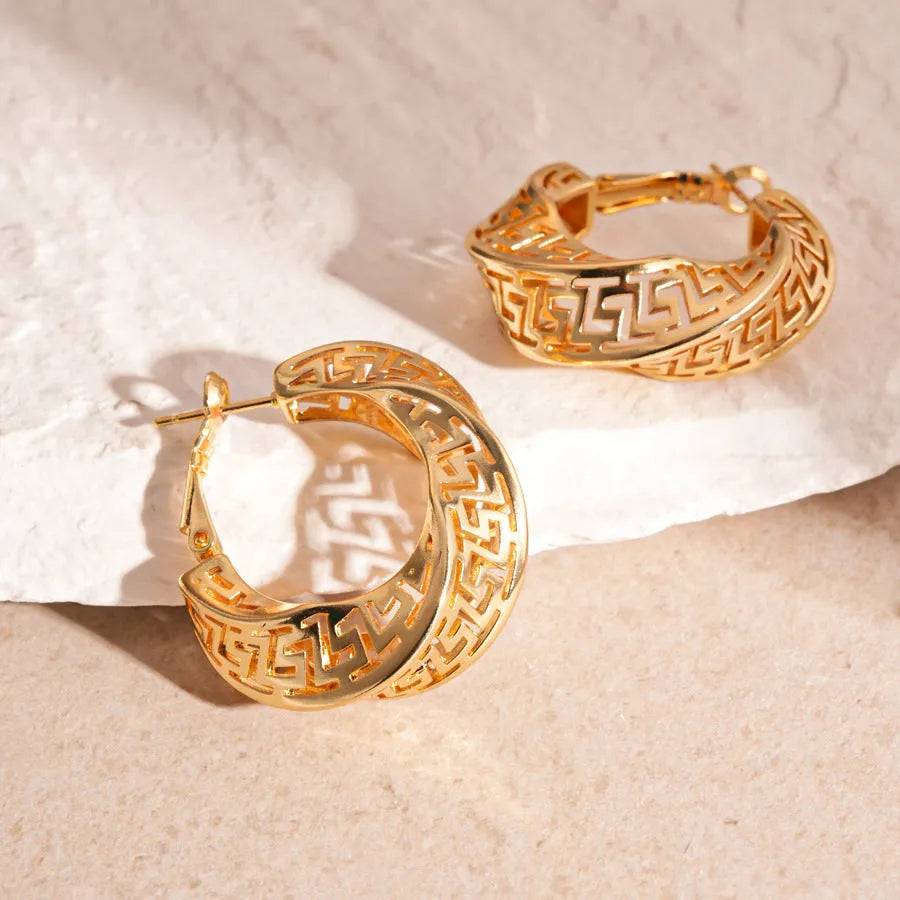 Women's twisted round geometric hollow stud earrings in silver or gold electroplated finish.