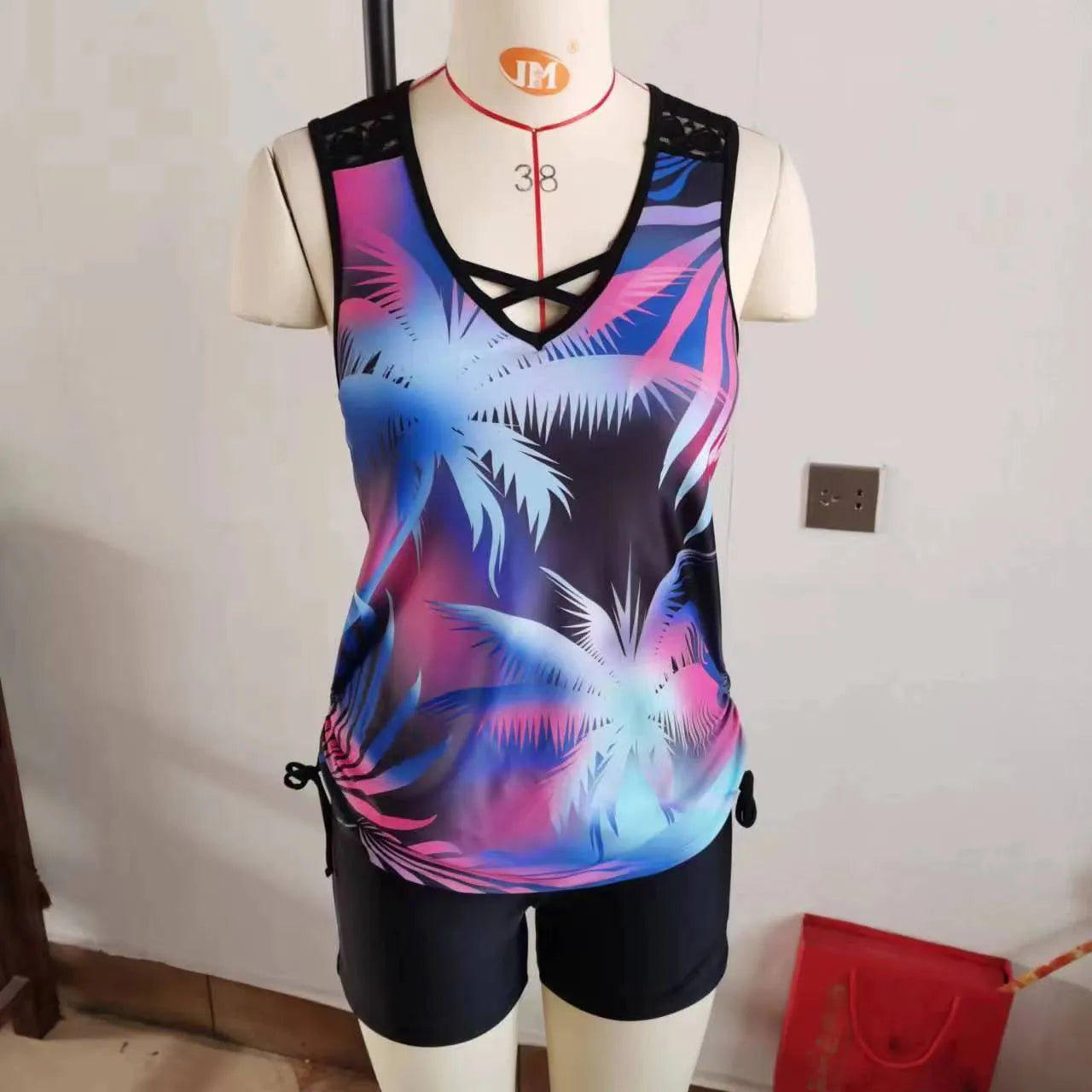 Women's blue floral printed lace two-piece bikini swimsuit on a mannequin.
