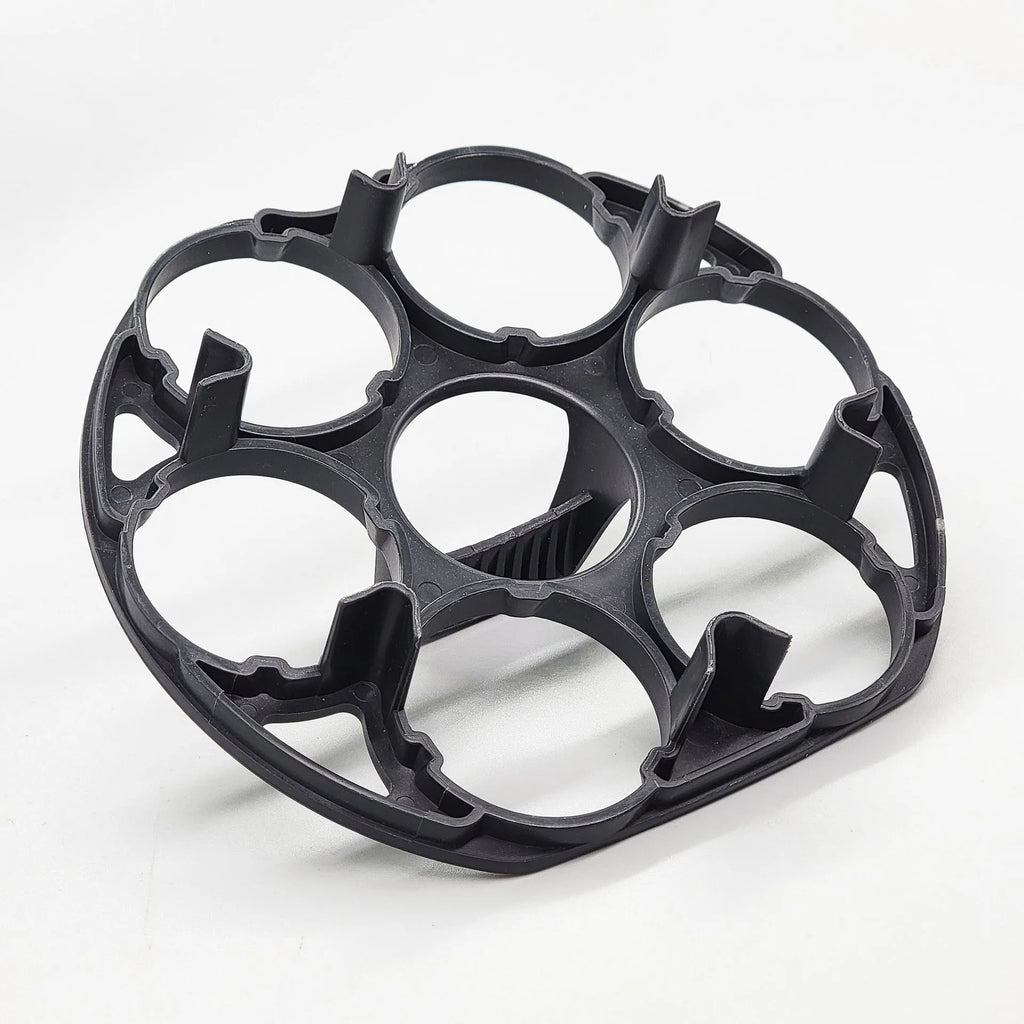 Black plastic egg holder basket on a kitchen countertop, showing its 13.8 cm length and retainer design.