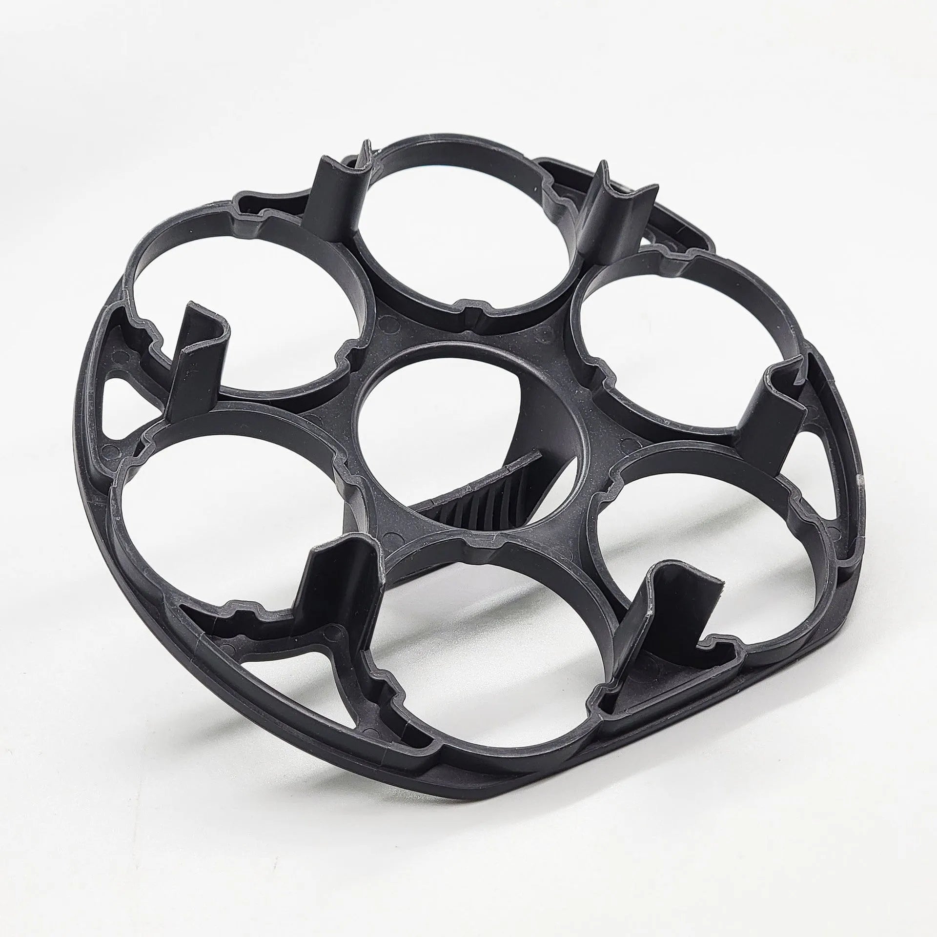 Black plastic egg holder basket on a kitchen countertop, showing its 13.8 cm length and retainer design.