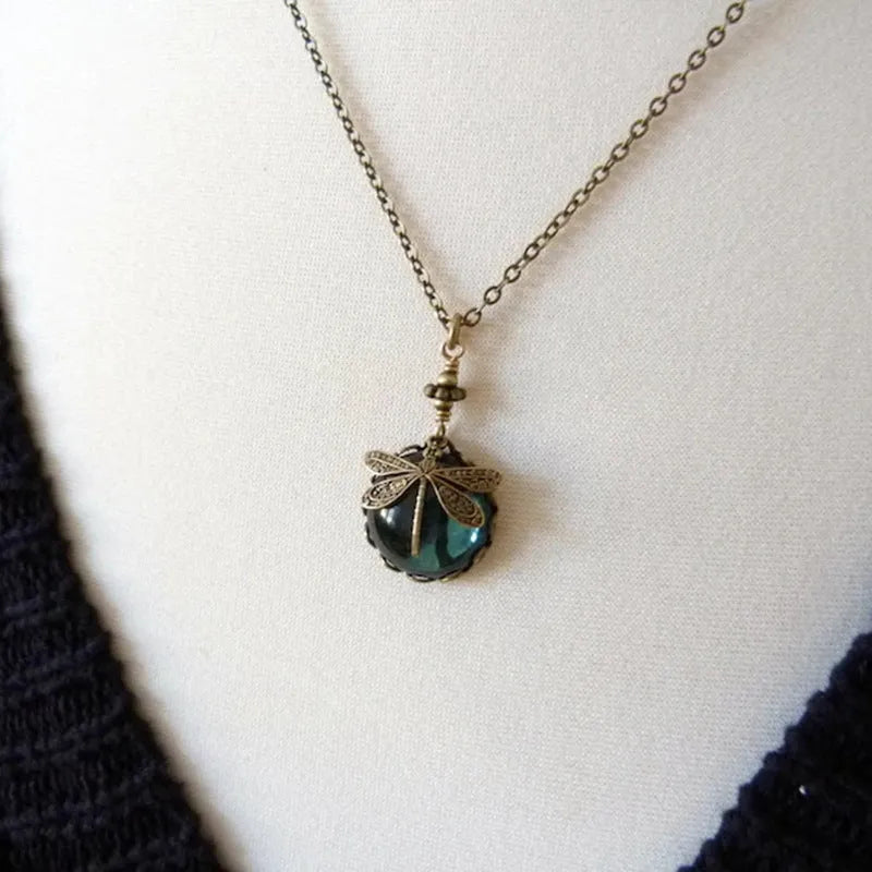 Yellow vintage bronze dragonfly pendant necklace on a silver chain, hand-carved design.