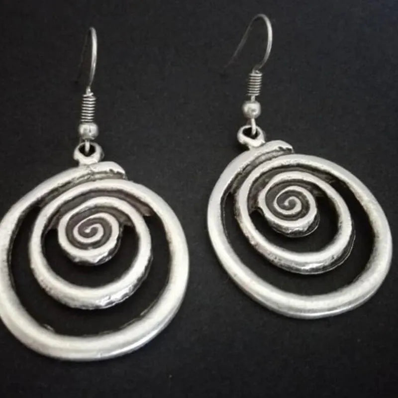 Retro geometric spiral distressed silver alloy earrings showing textured finish and spiral shape