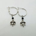 Silver-coloured alloy round hoop earrings with closed loop design on white background