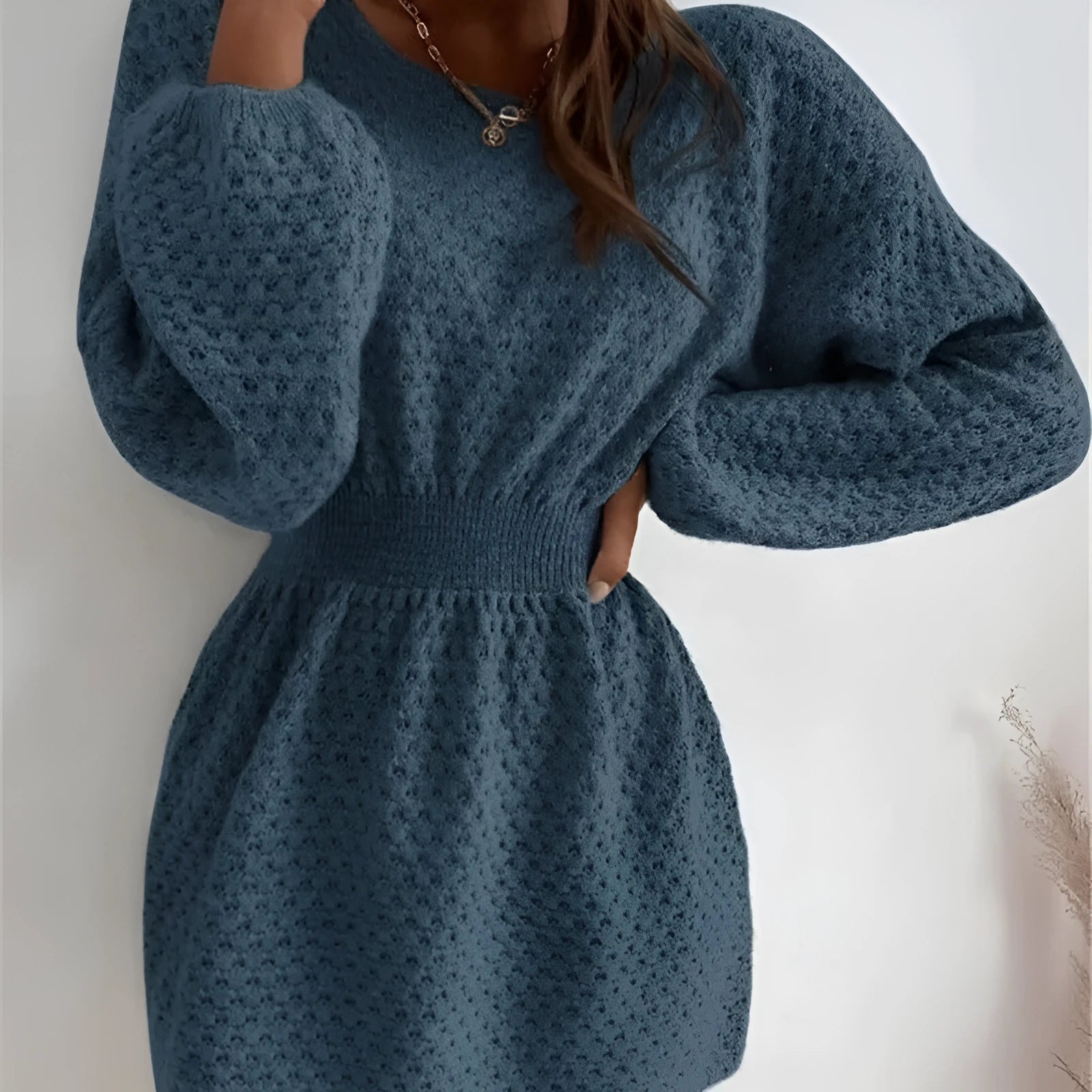 Blue women's knitted dress with hand-crocheted flower decoration and fitted waist design