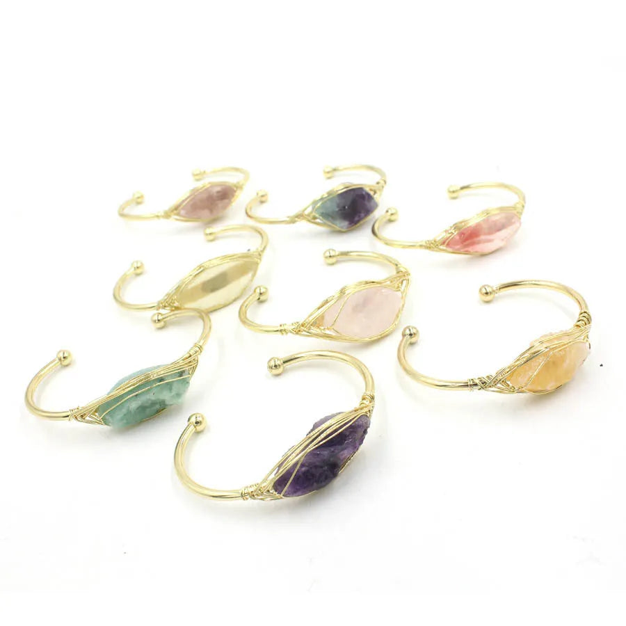 Raw gemstone winding bracelet with 8mm amorphous crystal beads in various colours on a white background.