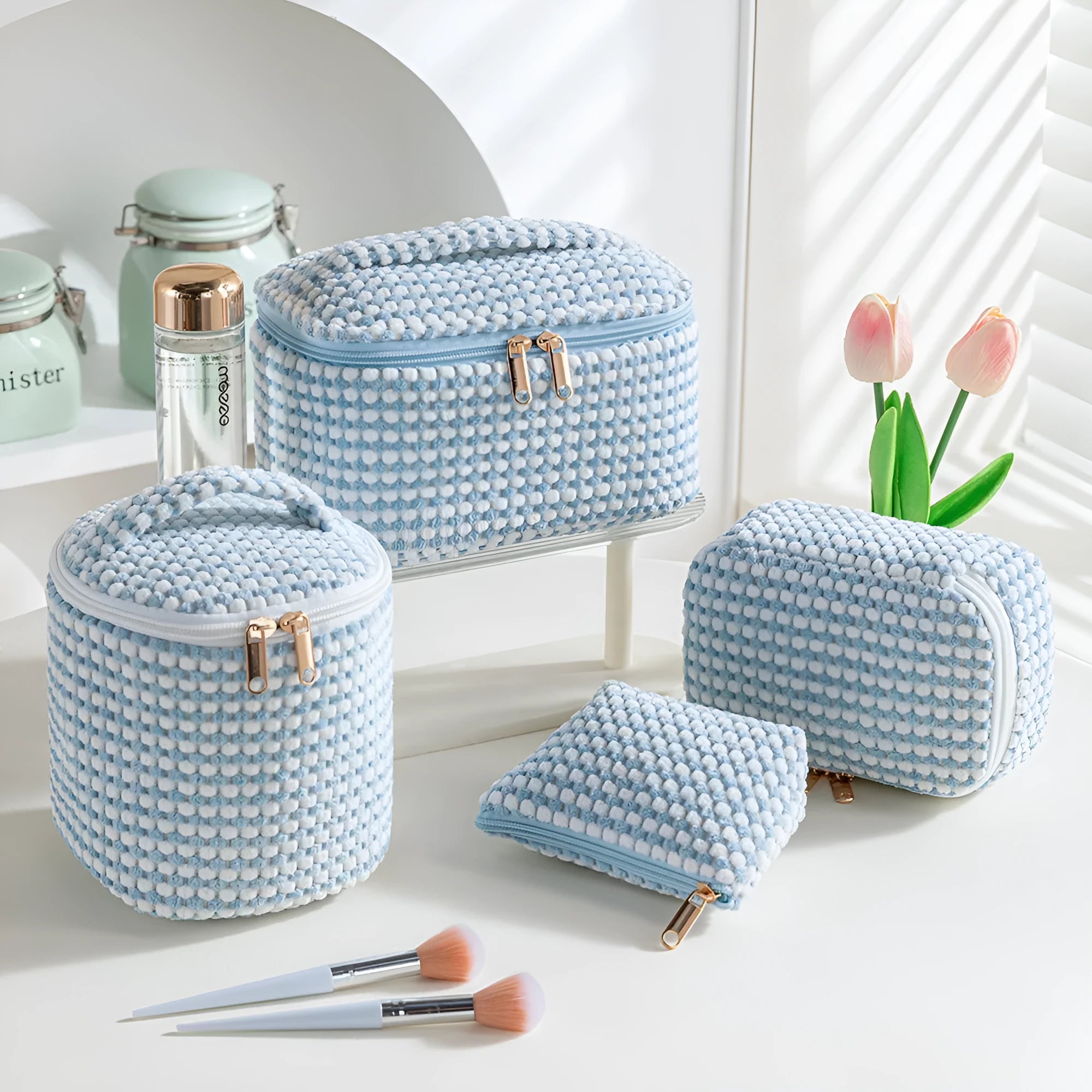 Four cube-shaped flannelette makeup bags in different colours for travel storage