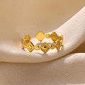 Gold diamond geometric titanium steel women's ring on a finger.