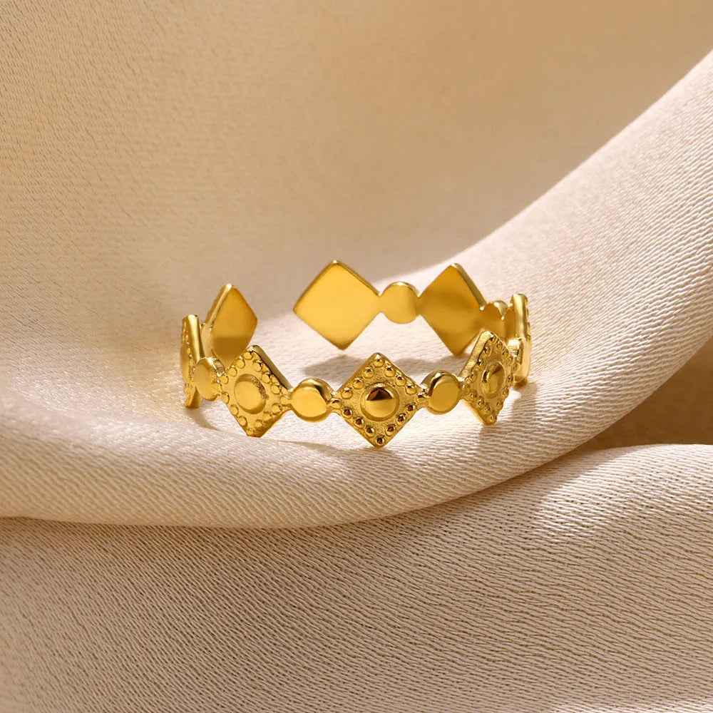 Gold diamond geometric titanium steel women's ring on a finger.