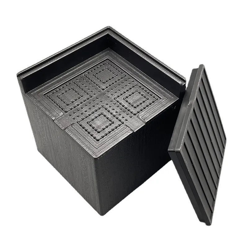 Four black circular plastic bed foot mats for furniture levelling and floor protection