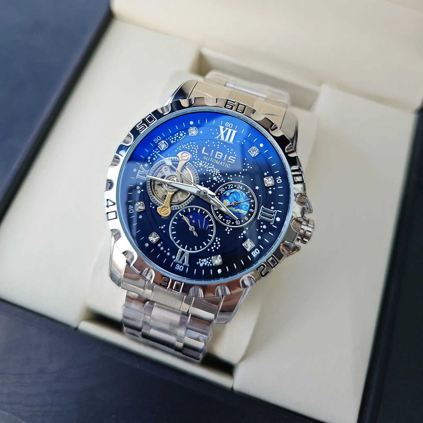 Men's silver stainless steel automatic watch with starry black dial and luminous hands on a black leather strap