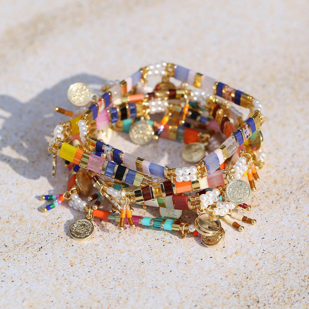 Women's imitation pearl and glass beaded bracelet showing six different colour variations with adjustable closure