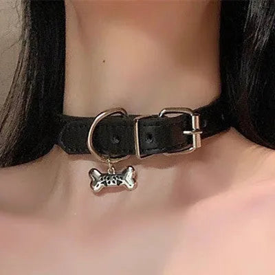 Black adjustable dog collar with bell showing three design options: LD leather, bone pattern, and cat's paw