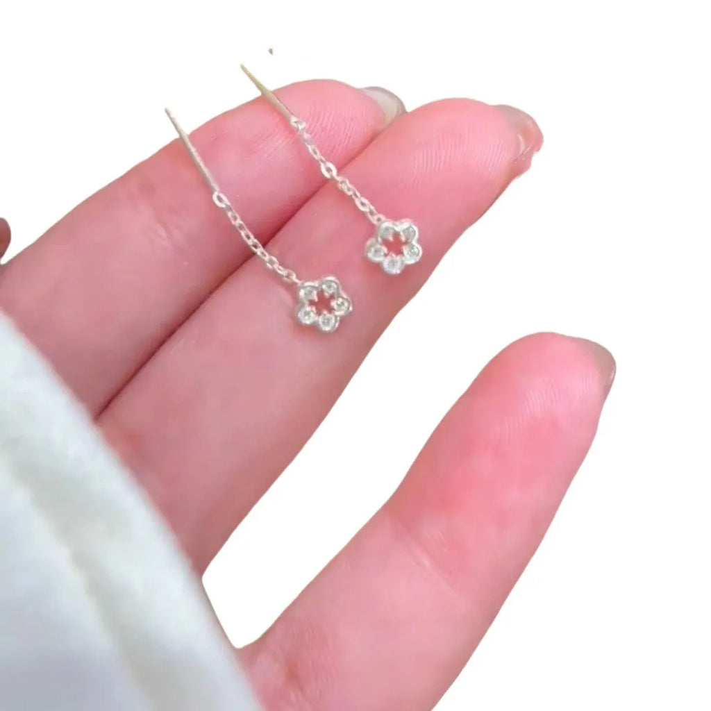 Silver hollow flower hanging earrings with petal design and alloy construction