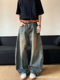 Man wearing retro blue distressed denim jeans with a slim-fit wide-leg cut.