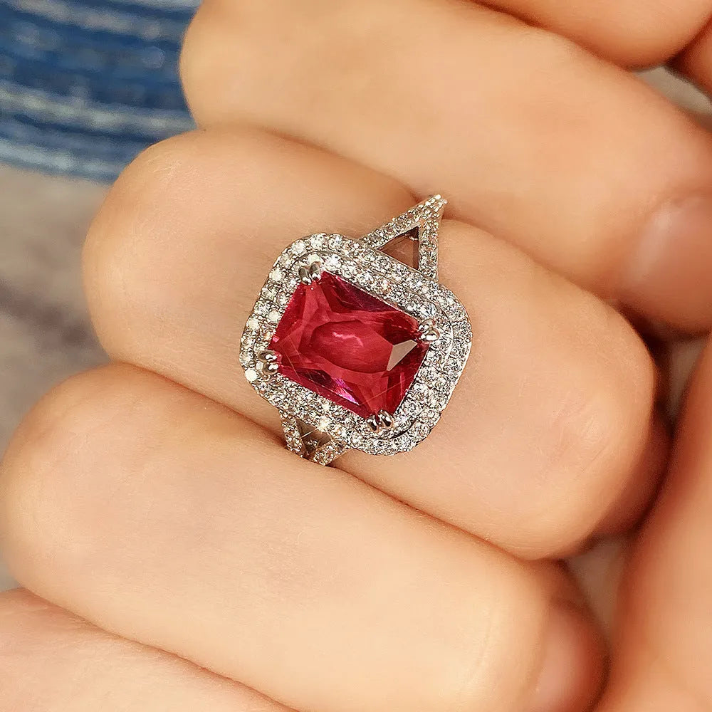 Square red copper women's ring with a central rhinestone on a white background.
