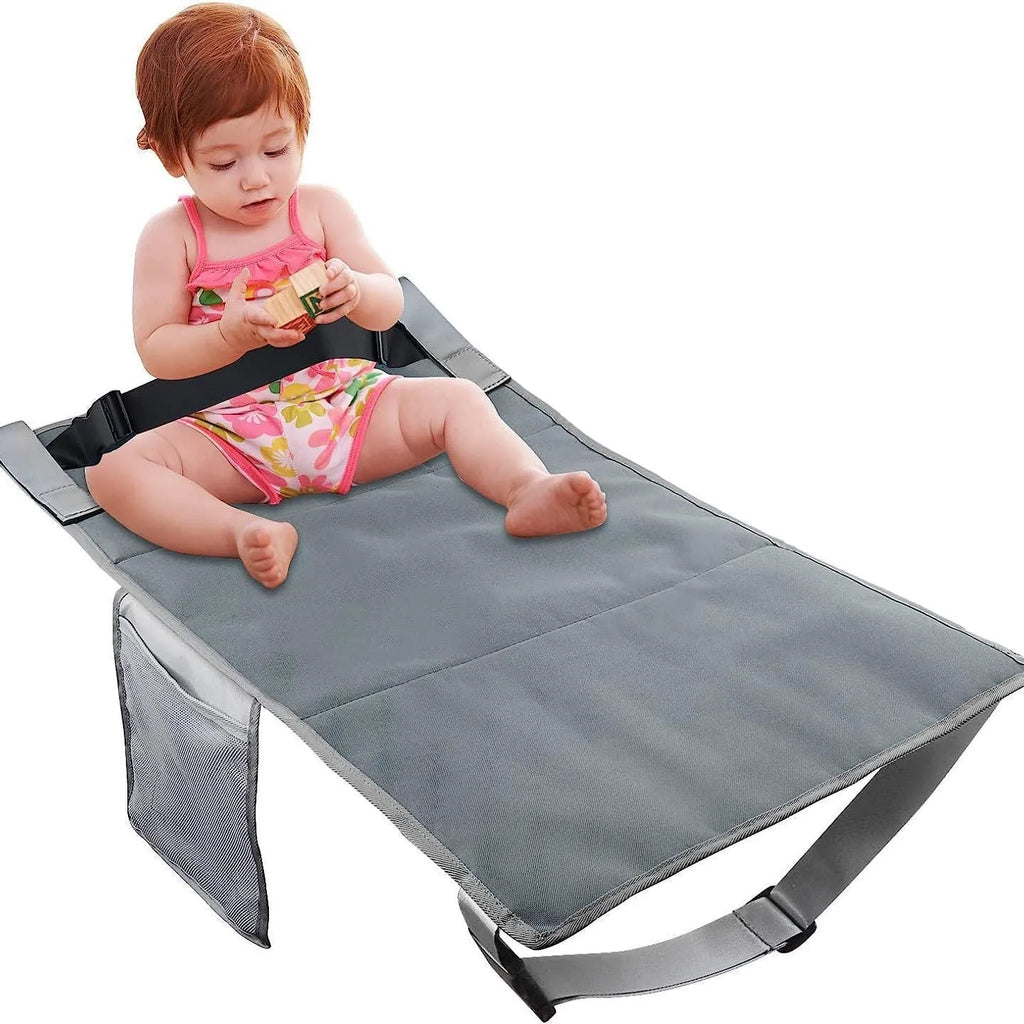 Blue portable children's aircraft seat extender with attached pedal and matching drawstring storage pocket.