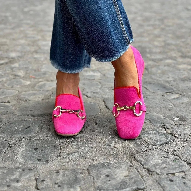 Green suede women's loafers with a metal fastener detail and a flat rubber sole.