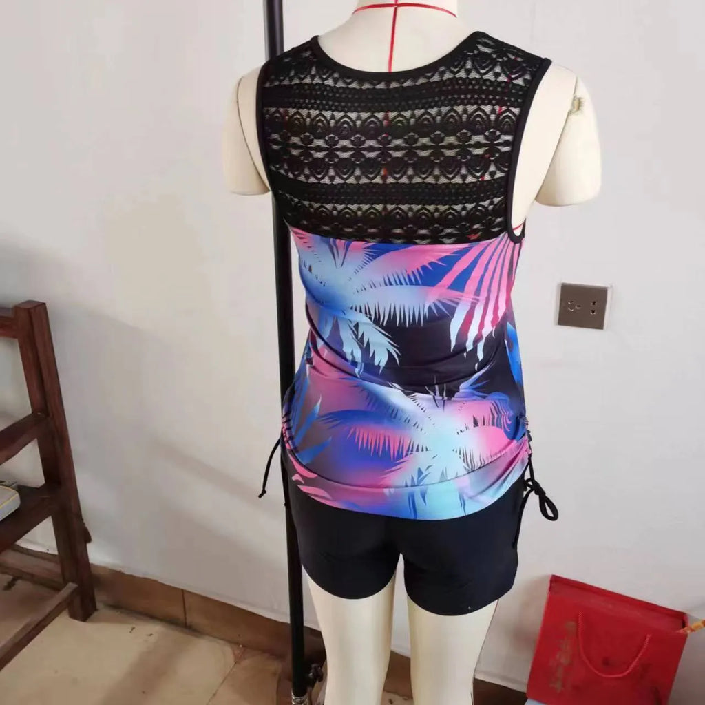 Women's blue floral printed lace two-piece bikini swimsuit on a mannequin.