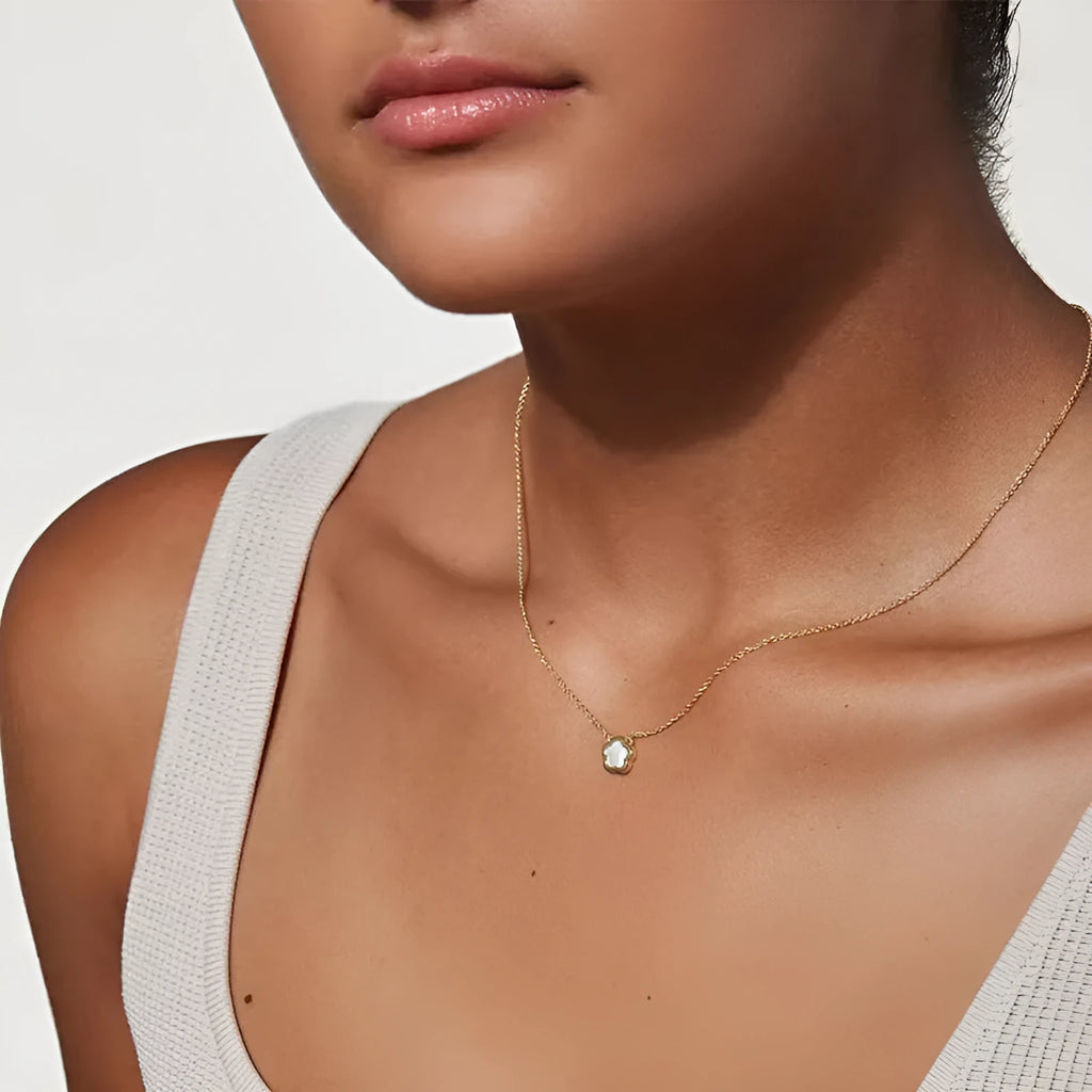 White mother of pearl shell flower necklace on a chain, shown in silver and gold tone finishes.